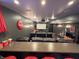 Cozy theater room with gray walls, tiered leather seating, a bar, and ambient lighting at 3610 Eagle Emblem Ct, Greenwood, IN 46143