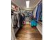 Spacious walk-in closet featuring custom shelving and hardwood floors, offering ample storage solutions at 3610 Eagle Emblem Ct, Greenwood, IN 46143