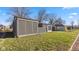 A view of the side yard with green grass and partial views of neighboring houses on a sunny day at 3661 Yellow Poplar Ct, Indianapolis, IN 46222