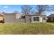 View of backyard featuring gray home, well-maintained lawn, and mature trees at 3661 Yellow Poplar Ct, Indianapolis, IN 46222
