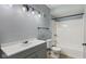 Well-lit bathroom featuring a gray vanity, shower-tub combo, and neutral tile flooring at 3661 Yellow Poplar Ct, Indianapolis, IN 46222