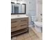 Updated bathroom featuring a modern vanity with a white countertop and a framed mirror at 3661 Yellow Poplar Ct, Indianapolis, IN 46222