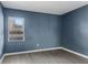 A simple room with wood-look laminate flooring and blue walls at 3661 Yellow Poplar Ct, Indianapolis, IN 46222