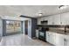 Bright kitchen featuring white cabinets, a black appliance suite, and neutral tile flooring at 3661 Yellow Poplar Ct, Indianapolis, IN 46222