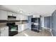 Contemporary kitchen featuring white cabinets, black appliances, and tile flooring at 3661 Yellow Poplar Ct, Indianapolis, IN 46222
