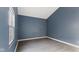 A simple room with wood-look laminate flooring and blue walls at 3661 Yellow Poplar Ct, Indianapolis, IN 46222