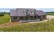 Aerial shot of a brick home featuring a metal roof, covered porch, and professionally landscaped yard at 3777 S 300 E, Anderson, IN 46017