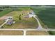 Aerial view of the entire property, showing the residence, outbuildings, pastures, and mature trees at 3777 S 300 E, Anderson, IN 46017