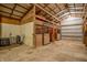 Barn featuring horse stalls with wood framing and metal bars, with hay and accessories present at 3777 S 300 E, Anderson, IN 46017