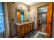 Well-lit bathroom features double sinks, granite counters, and wooden cabinets with modern fixtures at 3777 S 300 E, Anderson, IN 46017