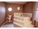 Corner soaking tub featuring tile surround and steps plus an octagon window providing natural light at 3777 S 300 E, Anderson, IN 46017