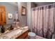 Bathroom with granite countertop sink, vanity, gray walls, decorative mirror, and shower at 3777 S 300 E, Anderson, IN 46017