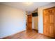 Spacious bedroom with wood floors, neutral walls, wood doors, and access to adjoining rooms at 3777 S 300 E, Anderson, IN 46017