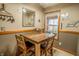 Cozy dining area featuring rustic wood table and chairs near a window with natural light at 3777 S 300 E, Anderson, IN 46017