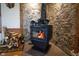 A cozy stone fireplace insert and wood pile with rustic design enhance this warm and inviting home at 3777 S 300 E, Anderson, IN 46017