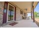 Inviting covered porch with ample seating, a fan, and natural light at 3777 S 300 E, Anderson, IN 46017