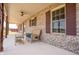 Inviting porch with brick facade, ceiling fan, furniture, and views of the yard at 3777 S 300 E, Anderson, IN 46017