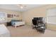 Comfortable bedroom with neutral carpet, white bed frame, a ceiling fan, and an office desk setup at 380 Winterset Way, Greenwood, IN 46143