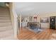 A spacious dining room with wood floors, a modern light fixture, and a stylish gray and white rug at 380 Winterset Way, Greenwood, IN 46143