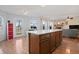 Open-concept kitchen with a large island and seamless flow into the living room and dining area at 380 Winterset Way, Greenwood, IN 46143