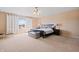 Bright main bedroom with large windows, neutral carpet, ceiling fan, and a spacious layout at 380 Winterset Way, Greenwood, IN 46143