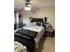 Bedroom with black bed frame, ceiling fan, and a window with curtains at 4291 Village Parkway W Cir # 8, Indianapolis, IN 46254