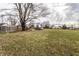 Expansive backyard featuring mature trees, providing ample outdoor space at 4355 W 450 S, Columbus, IN 47201