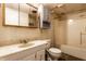 Bathroom boasts blue wallpaper, a marble sink, and a white toilet and shower at 4355 W 450 S, Columbus, IN 47201