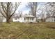 Charming single-story home with covered porch surrounded by mature trees and a large yard at 4355 W 450 S, Columbus, IN 47201