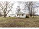 Inviting single-story home with covered front porch situated on a large lot with mature trees at 4355 W 450 S, Columbus, IN 47201