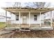 Quaint covered front porch with classic white railing and details enhancing the home's curb appeal at 4355 W 450 S, Columbus, IN 47201