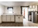 View of kitchen featuring cabinets, window and doorway to another room with water heater at 4355 W 450 S, Columbus, IN 47201