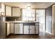 Well-lit kitchen with tile flooring, ample cabinet space, and a window overlooking the backyard at 4355 W 450 S, Columbus, IN 47201