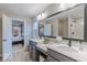 Bathroom with double vanity, neutral gray cabinets, and a view into the bedroom at 4738 E Shadowbrook Dr, Camby, IN 46113