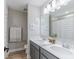 Bright bathroom featuring double vanity with white countertops, gray cabinets, and decorative accents at 4738 E Shadowbrook Dr, Camby, IN 46113