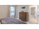 Neutral bedroom featuring a double bed, dark wood dresser and window with natural light at 4738 E Shadowbrook Dr, Camby, IN 46113
