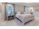 Bright bedroom featuring a comfortable bed, stylish rug, and soft, neutral decor at 4738 E Shadowbrook Dr, Camby, IN 46113