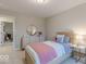 Cozy bedroom featuring a twin-size bed, dresser, and warm, ambient lighting at 4738 E Shadowbrook Dr, Camby, IN 46113