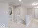 Carpeted upstairs hallway with white railing and neutral paint throughout at 4738 E Shadowbrook Dr, Camby, IN 46113