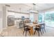 Modern kitchen with stainless steel appliances, white cabinetry, and an island with seating, perfect for entertaining at 4738 E Shadowbrook Dr, Camby, IN 46113