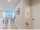 View of the living room and hall bathroom featuring a view of the staircase and large windows at 4738 E Shadowbrook Dr, Camby, IN 46113