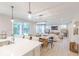 Open concept living room, dining room, and kitchen with hardwood floors and modern lighting at 4738 E Shadowbrook Dr, Camby, IN 46113