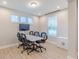 Office space with a large window, modern lighting and table with office chairs at 4738 E Shadowbrook Dr, Camby, IN 46113