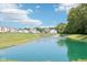 Picturesque community pond with a fountain, surrounded by green space and houses at 4738 E Shadowbrook Dr, Camby, IN 46113