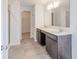 Bathroom featuring double sinks, tile floors, and a shower with glass doors at 4739 E Shadowbrook Dr, Camby, IN 46113