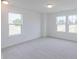 Bright bedroom with carpet and two windows offering ample natural light at 4739 E Shadowbrook Dr, Camby, IN 46113