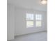 Empty bedroom with carpeted floors, white walls, and two windows allowing plenty of natural light at 4739 E Shadowbrook Dr, Camby, IN 46113