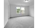 Bright bedroom featuring neutral carpet, white walls, with a double-window allowing ample natural light at 4739 E Shadowbrook Dr, Camby, IN 46113