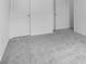 Neutral carpeting in a bedroom with a door and neutral paint at 4739 E Shadowbrook Dr, Camby, IN 46113