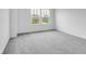 This bedroom features two windows with neutral paint and carpeting at 4739 E Shadowbrook Dr, Camby, IN 46113